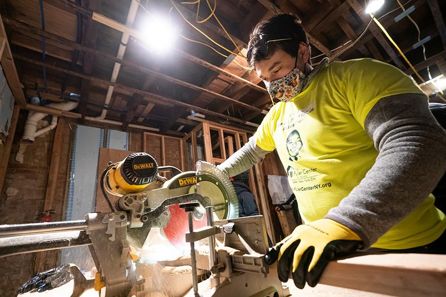 A student uses the hand saw at the Fuller house in Yonkers.