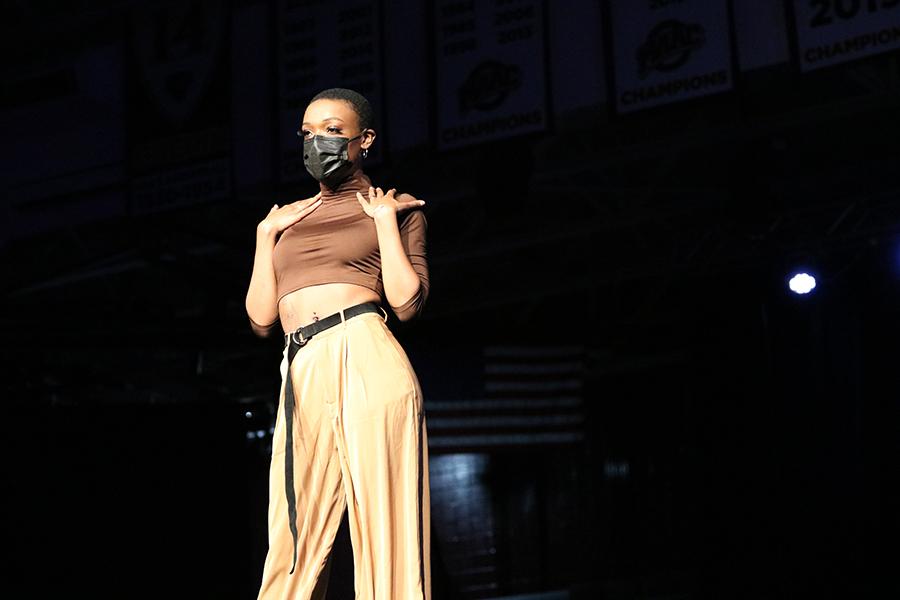 A student poses at the spring 2021 fashion show.