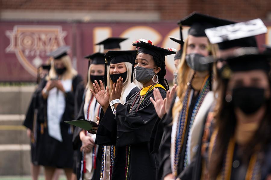 Students stand and applaud at the 2021 in-person recognition ceremony.