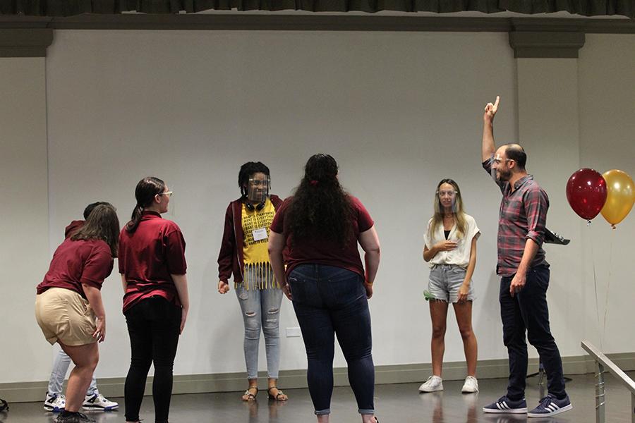 Nathan Lucrezio works with a group of students on vocals.