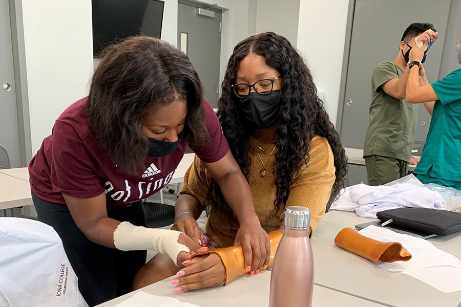 Two students in the OT program practice splintering.