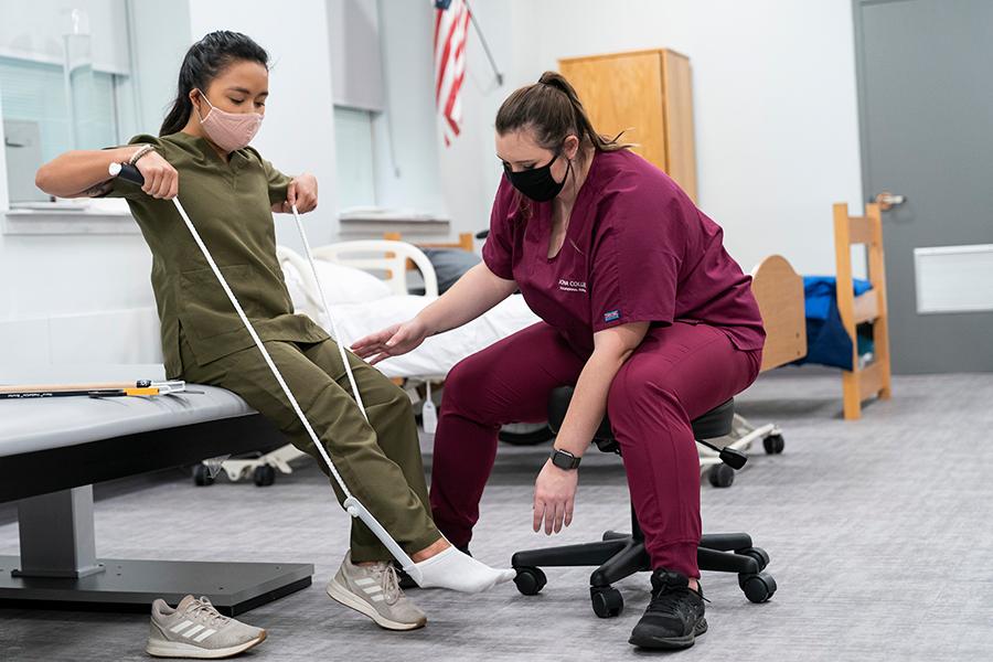 Iona college students practice putting a foot brace on.