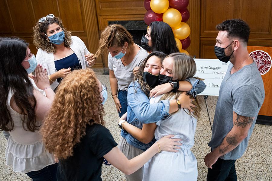 Students hug when they learned of the BHWET check.