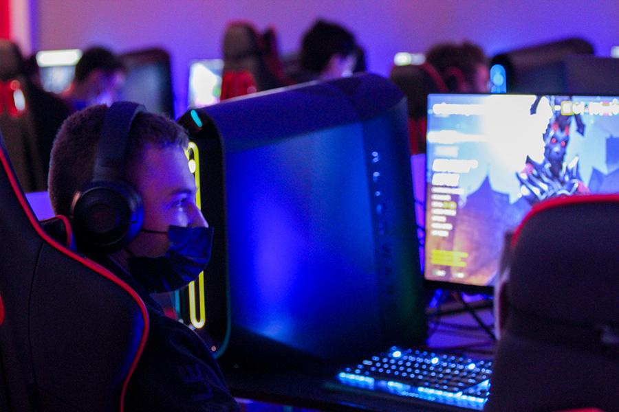 A student gets ready to play a game in the esports room.