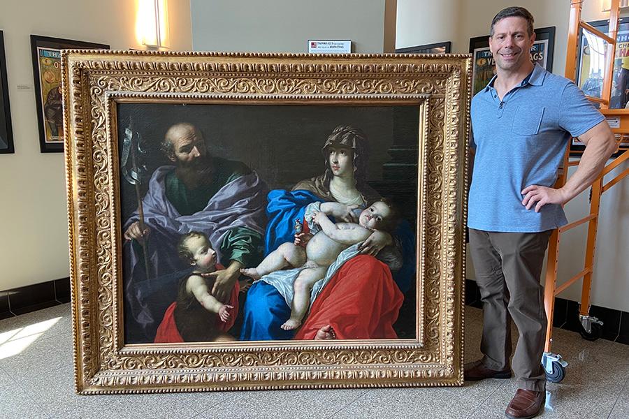 Tom Ruggio poses with the Dandini painting.