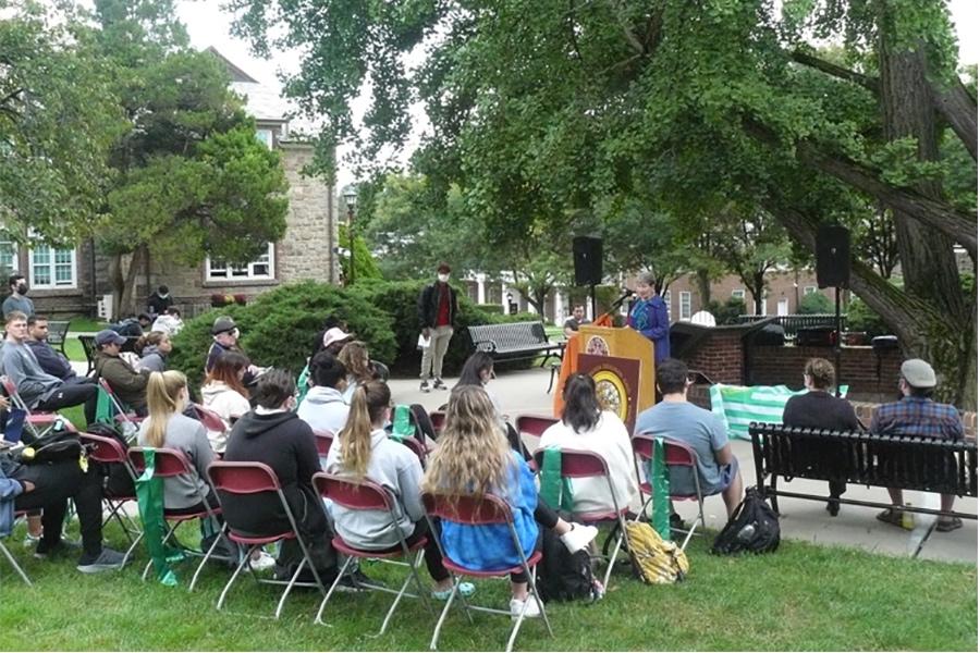 Sister Kathleen speaking by the Ginkgo tree.