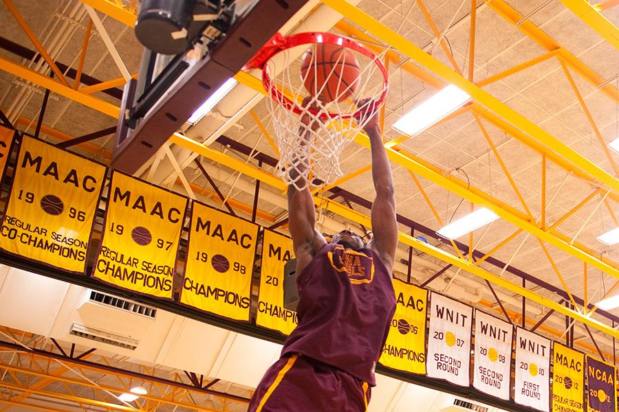 Iona College club basketball dunking on the court.
