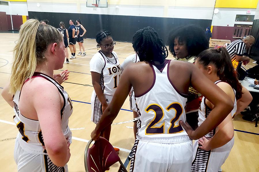 Iona College women's club basketball huddle up during a game.