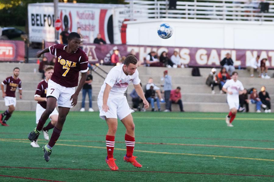 Iona men's club soccer head the ball.