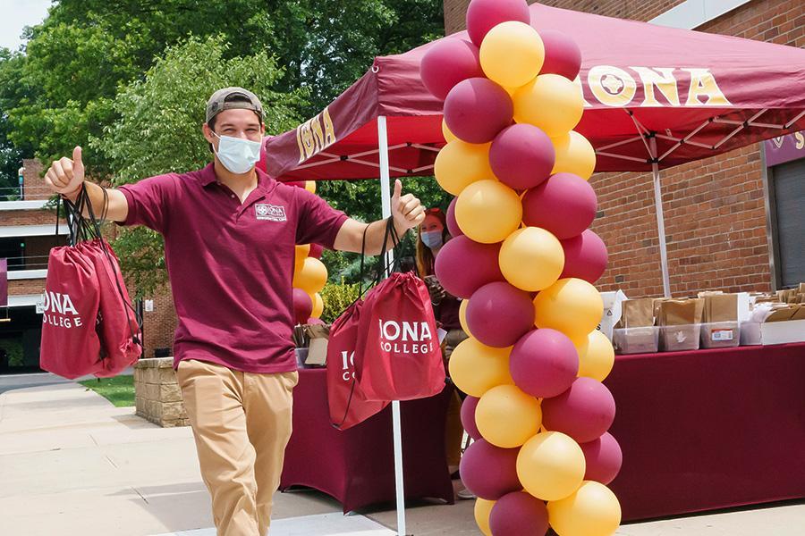 Eddie Maffia handing out swag to students on orientation day.