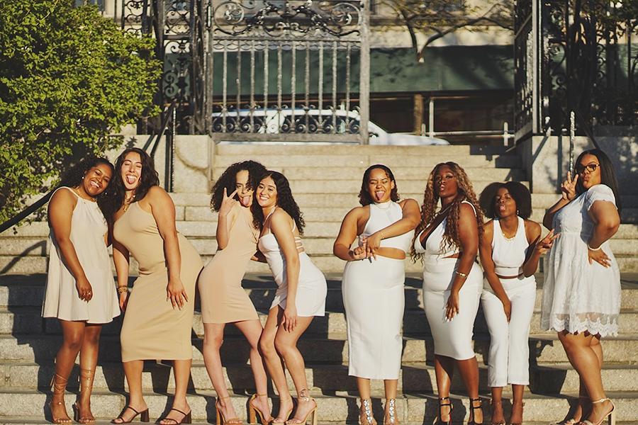 Lambda Theta Alpha 2022 members on steps in the city.