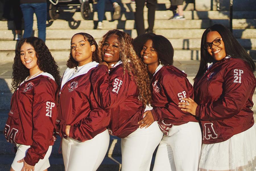 Lambda Theta Alpha 2022 members in maroon jackets.