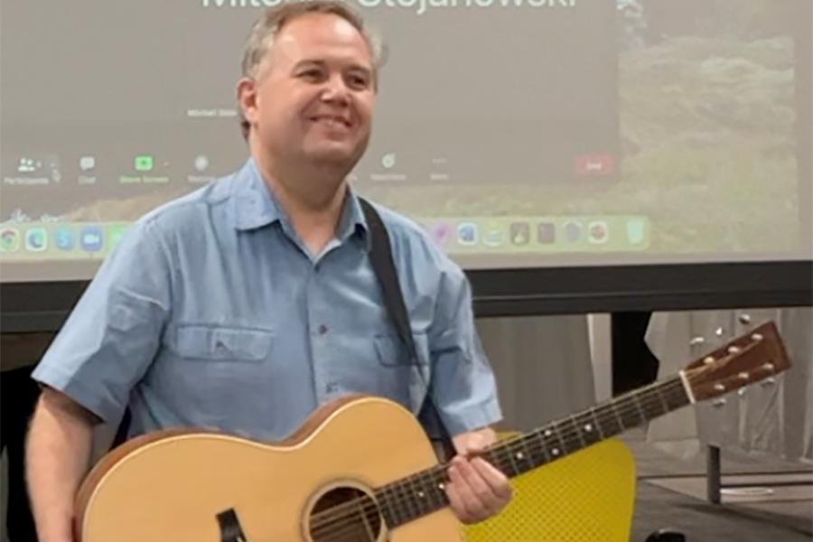 Prof. Lubo plays guitar.