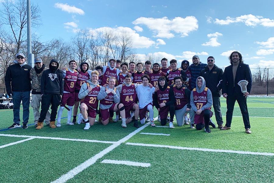 The Iona men's lacrosse club team pose on a field on a sunny day.