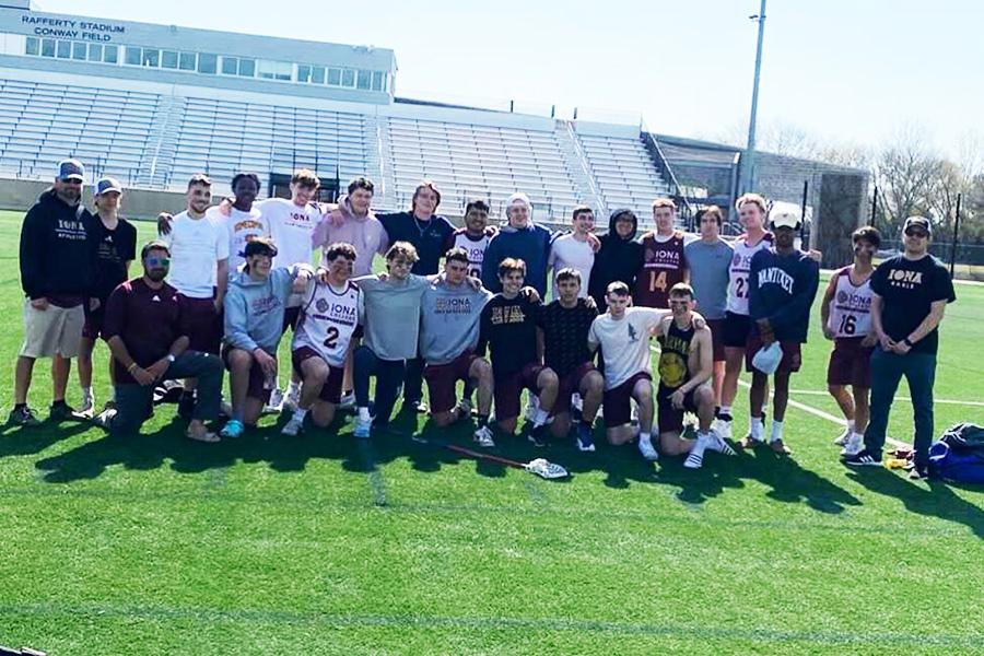 The Iona men's lacrosse club team after a practice at a stadium field.