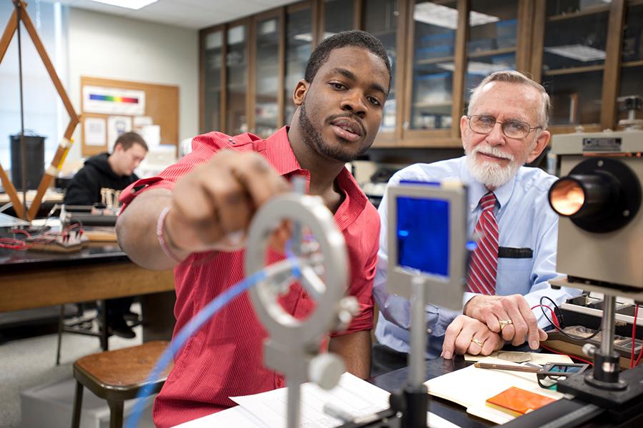 Victor Stanionis works with a student in the lab.