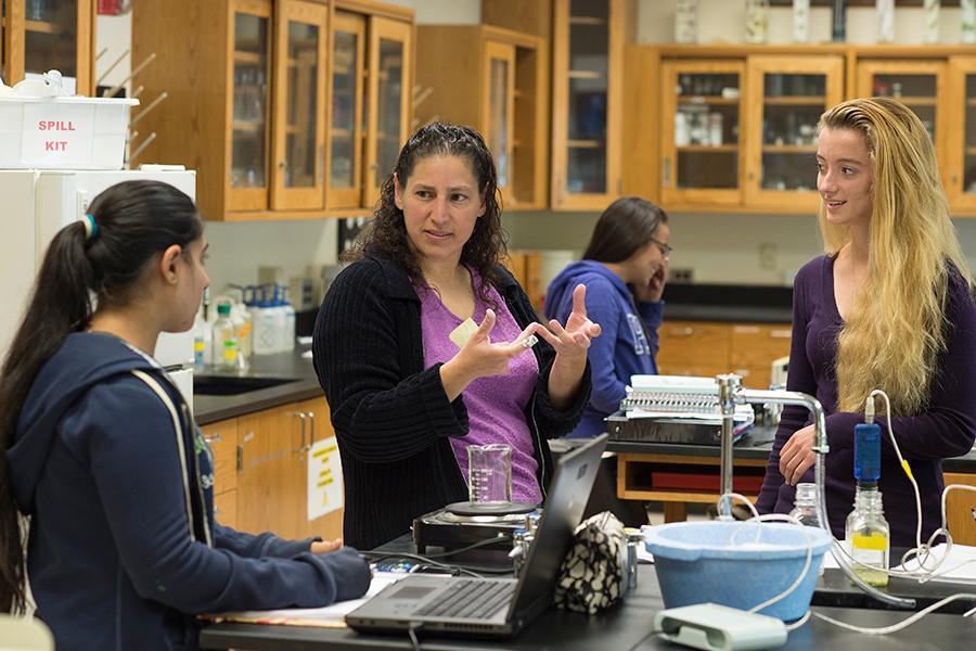 Teresa D'Aversa works with students in the biology lab.
