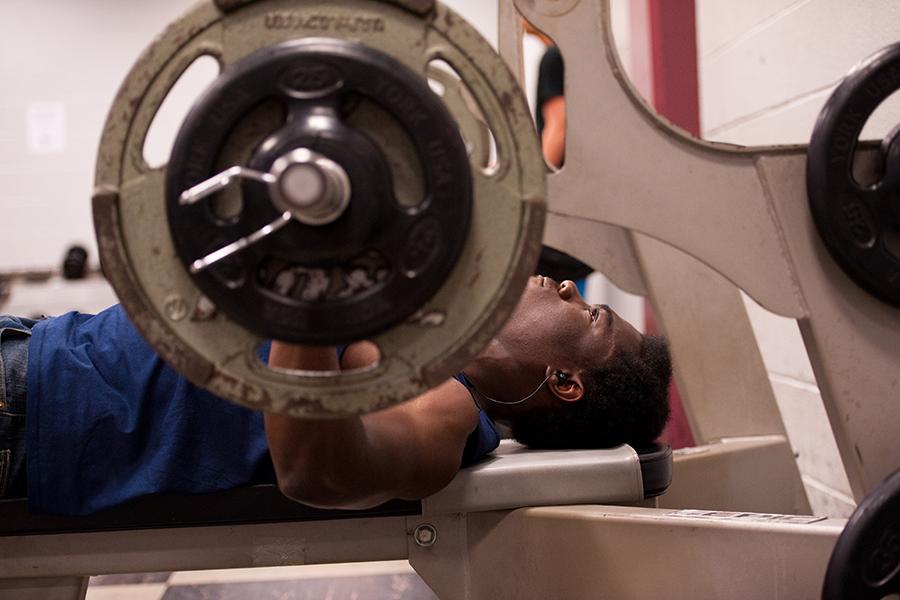 A student bench presses.