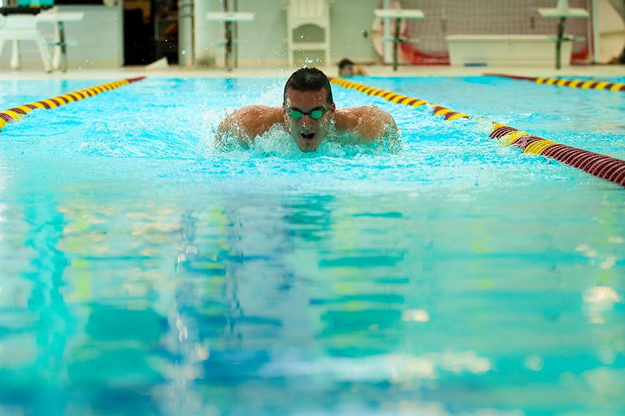 A swimmer practices the butterfly stroke in the Hynes Pool.