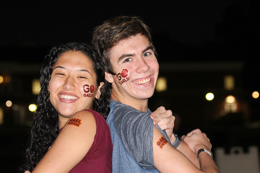 Two students show their tattoos at a GaelGate party.