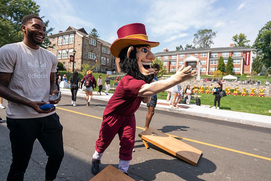 Killian plays against Jean Louis in cornhole.