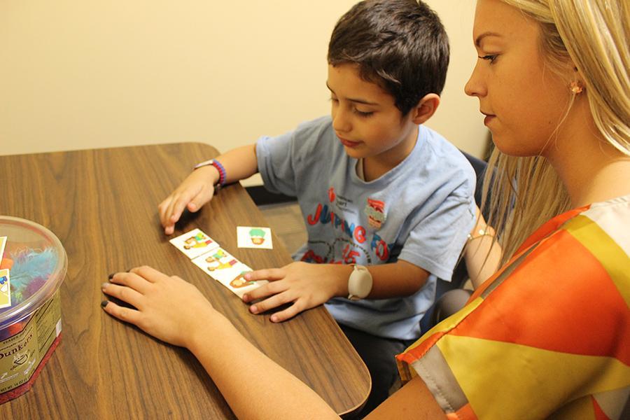 A speech therapist works with a young client.
