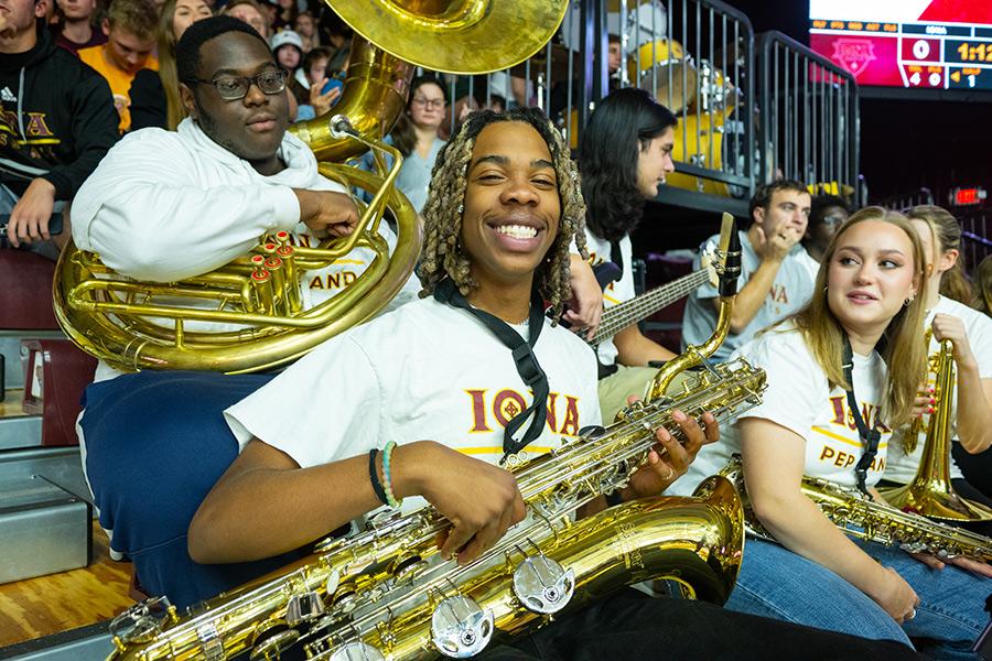 The baritone sax player smiles at an Iona home game.