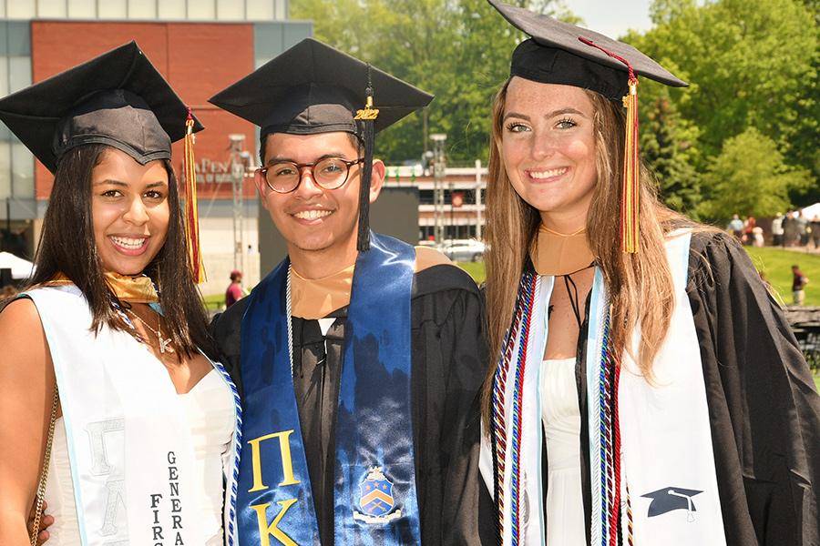 Three graduates at the 2022 Commencement ceremony.
