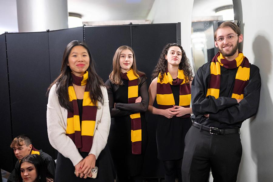 Four of the Iona singers backstage smiling.