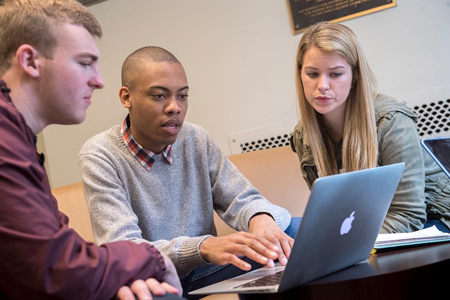Three students work on their online MBA degree project.