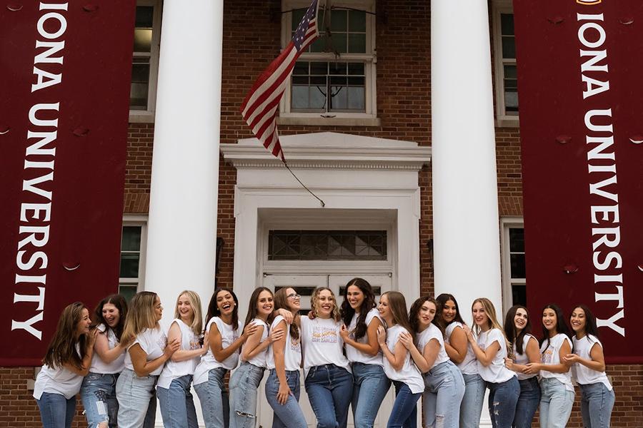 The dance team on the steps of McSpedon with Iona University banners.