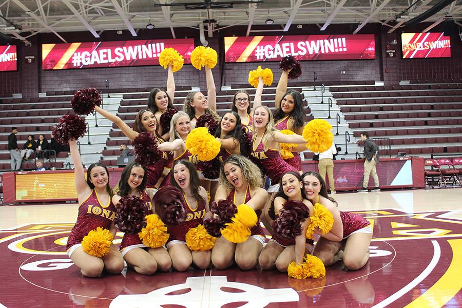 The dance team after a basketball game and Gaels Win is displayed on the banners.