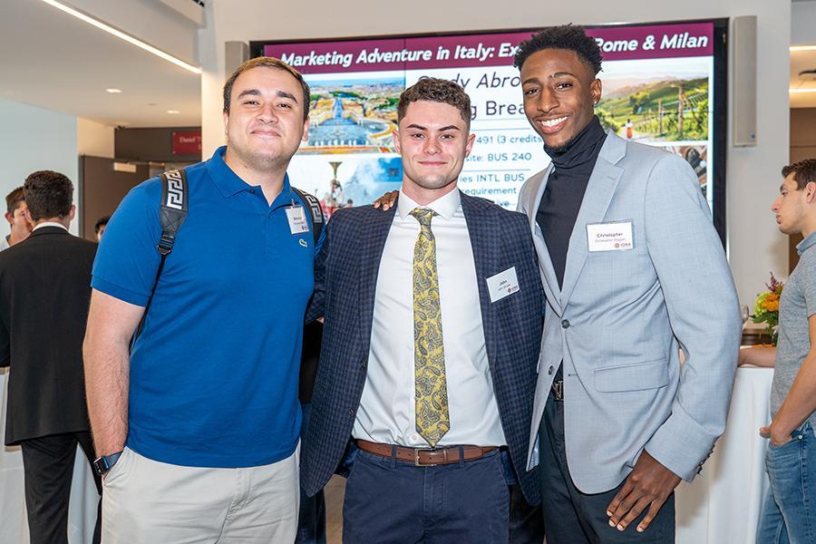 Three mentoring students at a Gaels Go Further event.