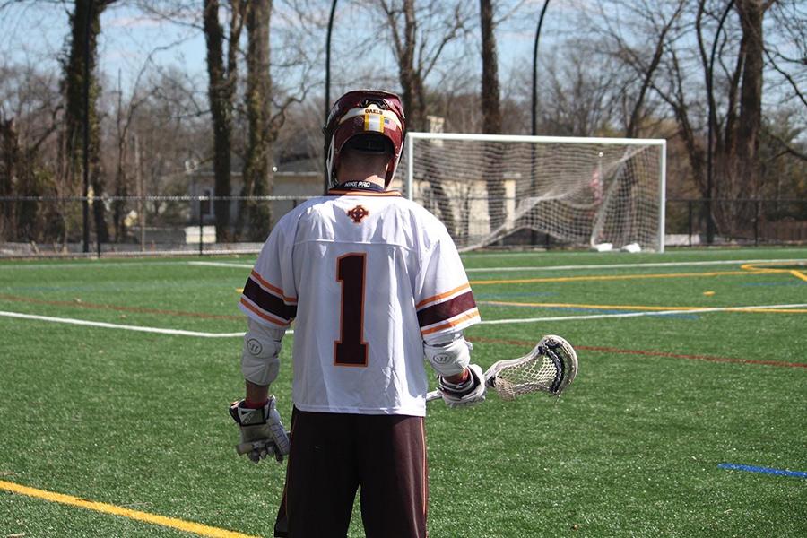Player number 1 from the Lacrosse team faces away from the camera.