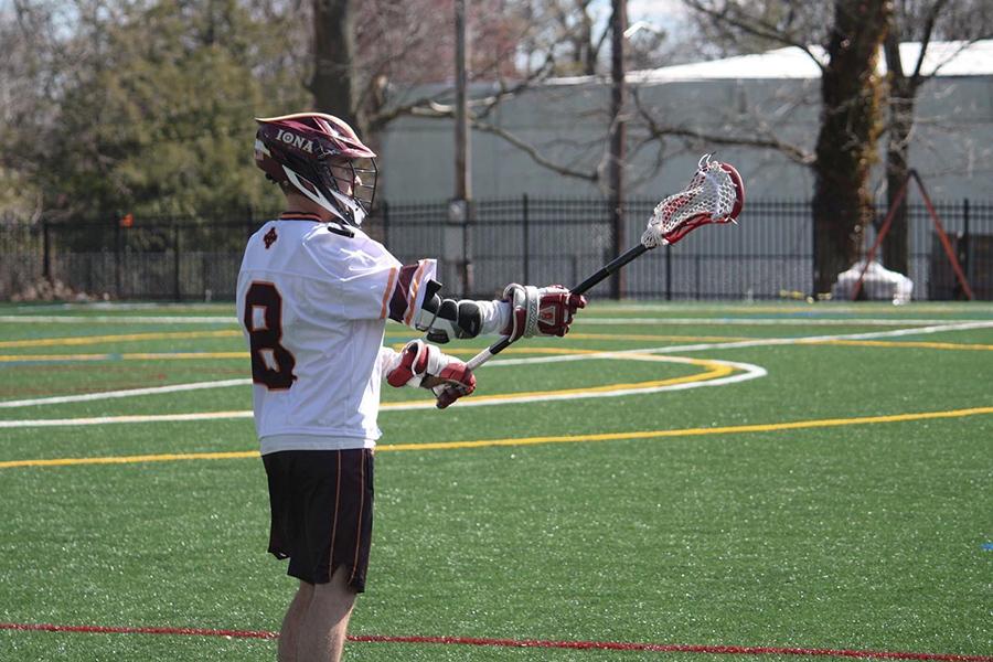 Player number 8 from the Lacrosse team catches a ball.
