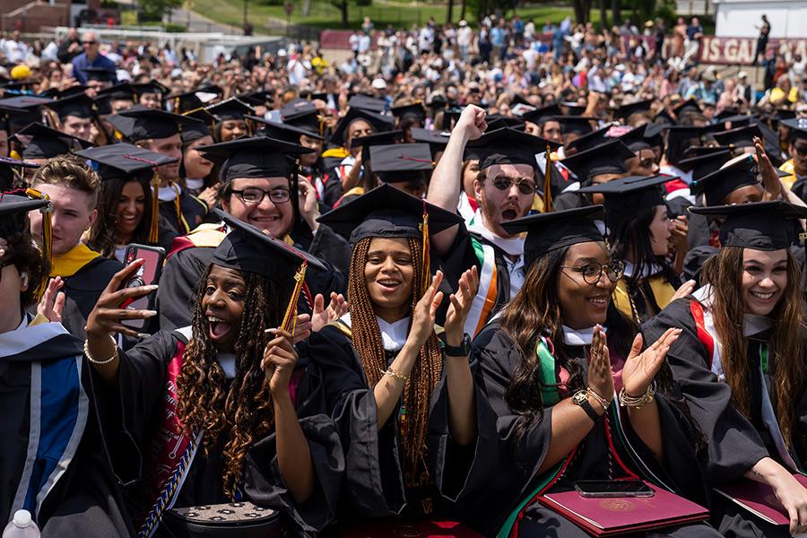 The class of 2023 sitting at the ceremony and clapping.