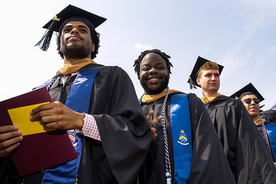 Four 2023 graduates look at the camera and smile.