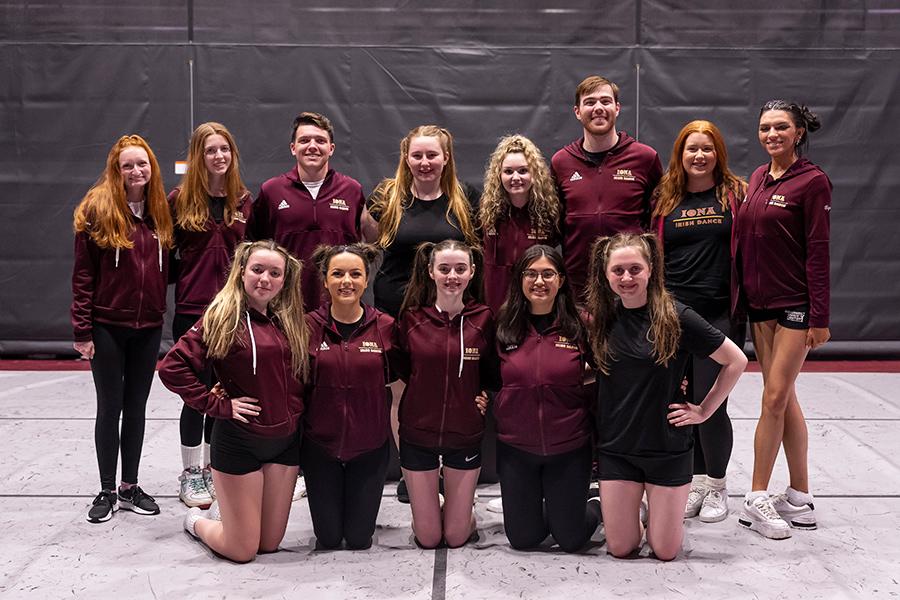 The Irish Step dance group pose for the camera and smile.