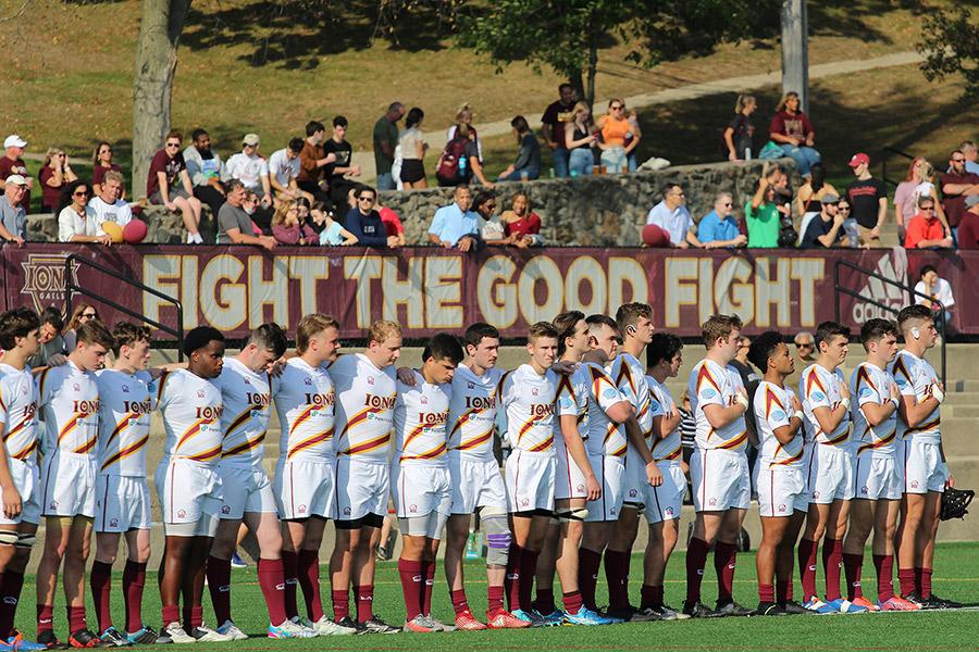 The Rugby team standing for the National Anthem.