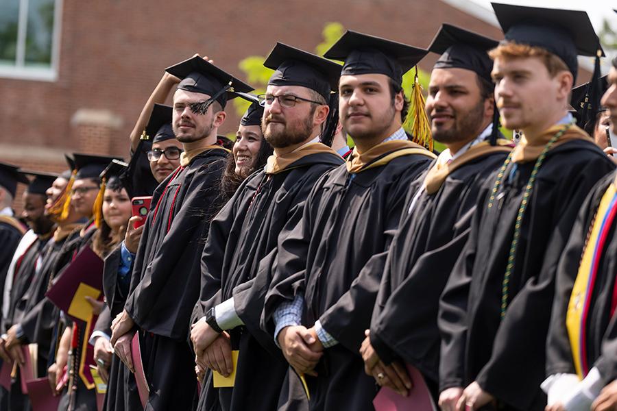 2023 Candidates standing at Commencement.