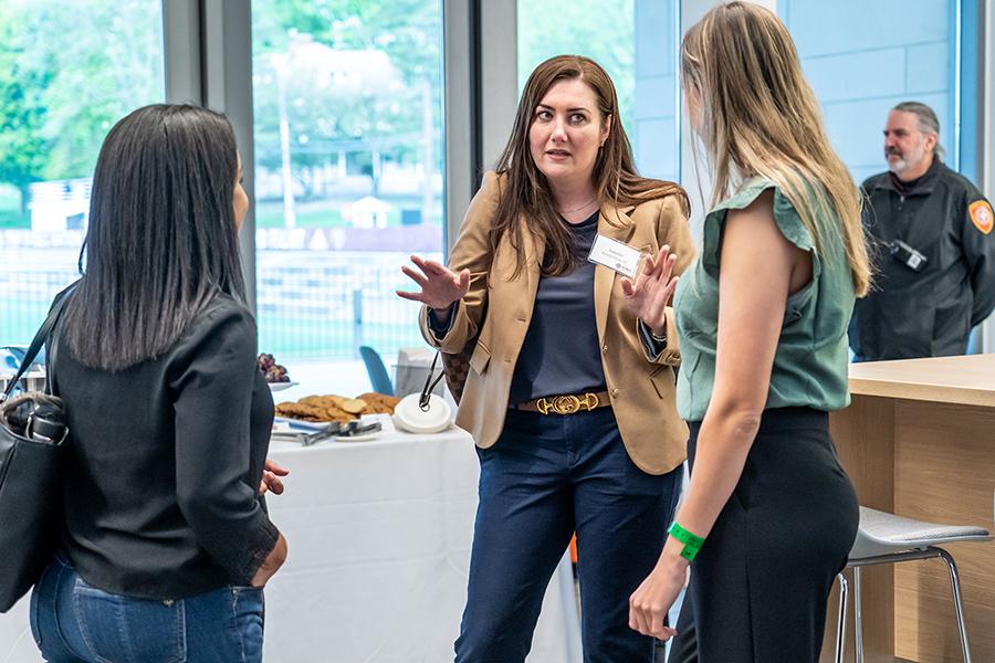 Two mentors talk with a mentee.