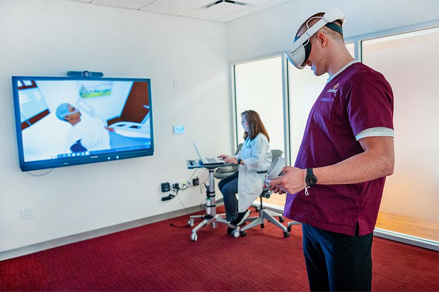 A nursing student uses the VR headset.