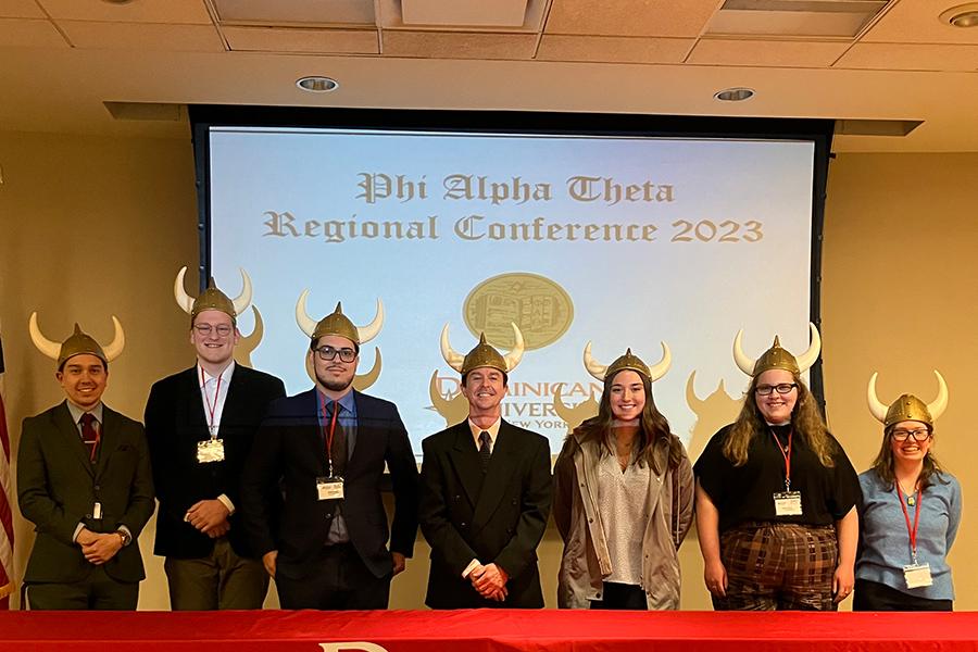 Students and Dr. Hughes in toy Viking helmets at the conference.