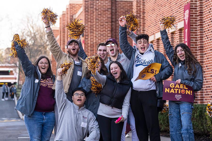 Gael guides celebrate and raise their pom-poms at an open house.