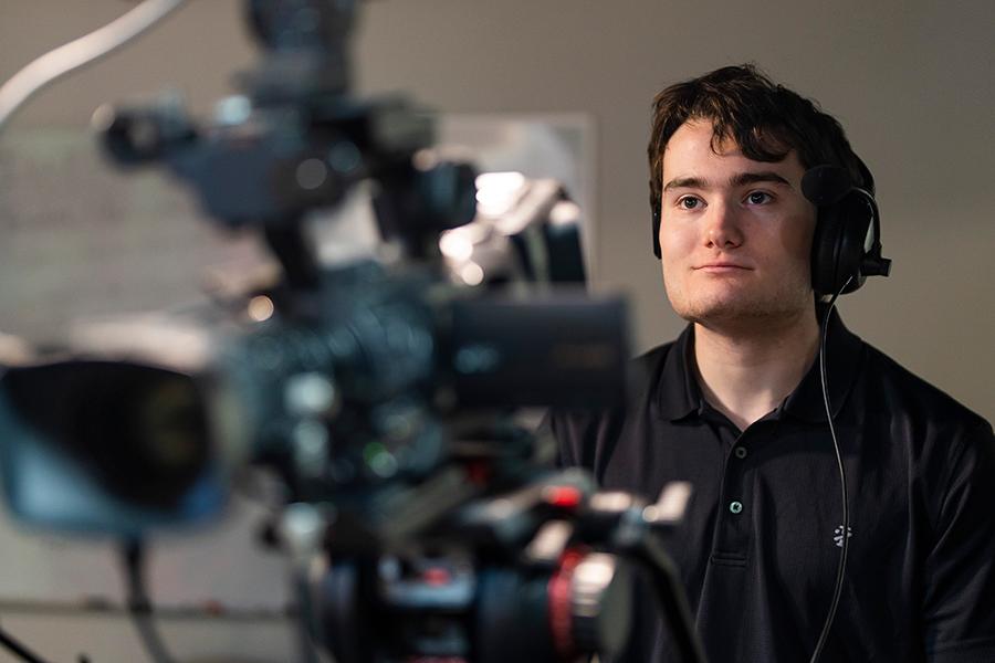A student in the media and strategic communication department works the camera.