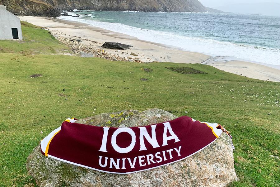 An Iona University scarf on Keem Bay Beach in Ireland.
