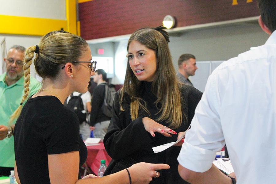 A student shares her resume at the career fair.