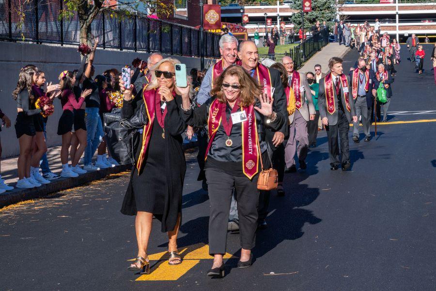 Alumni walking down street in parade