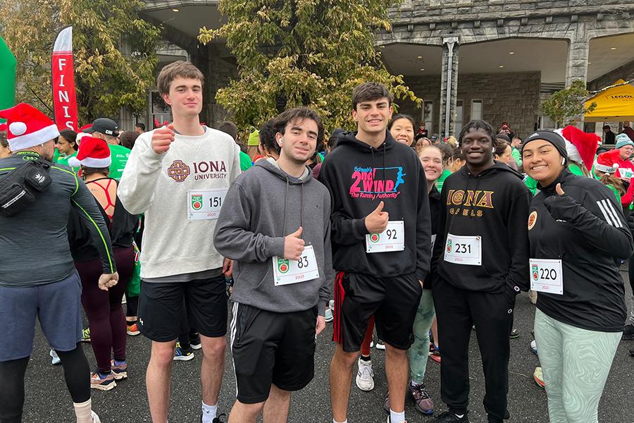 The co-ed running team giving a thumbs up before a race.