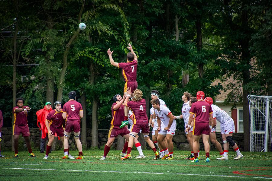 The rugby team catching the ball in play.